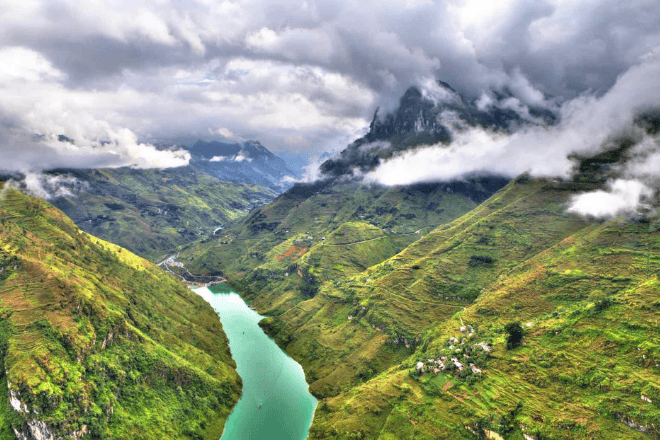 Ma Pi Leng Pass with rugged limestone peaks and green valleys.