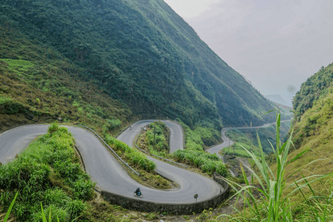 "Tham Ma Pass in Ha Giang, Vietnam, with its winding roads and scenic mountain backdrop."